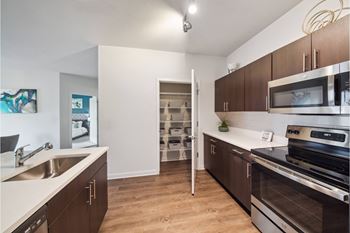 luxury kitchen with custom cabinetry and stainless steel appliances at Carrick Bend apartments
